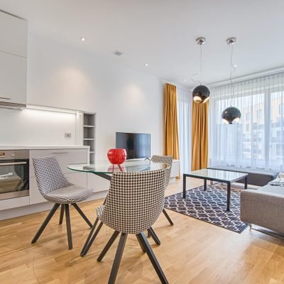 two chairs with glass table on living room near window.jpg